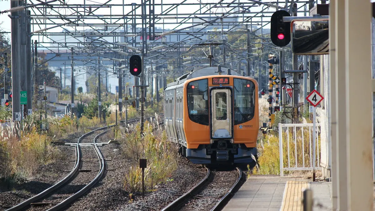Yellow Abukuma Express AB900 series train departing from Tsukinoki Station