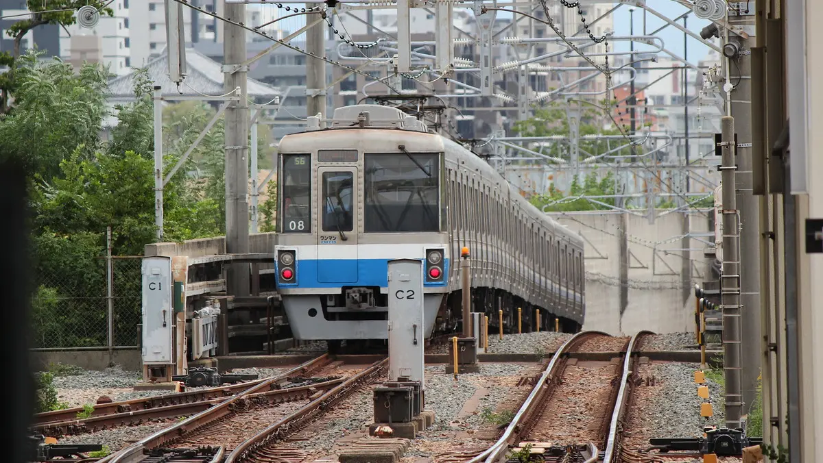 Subway Hakozaki Line 1000N series train departing Kaizuka Station