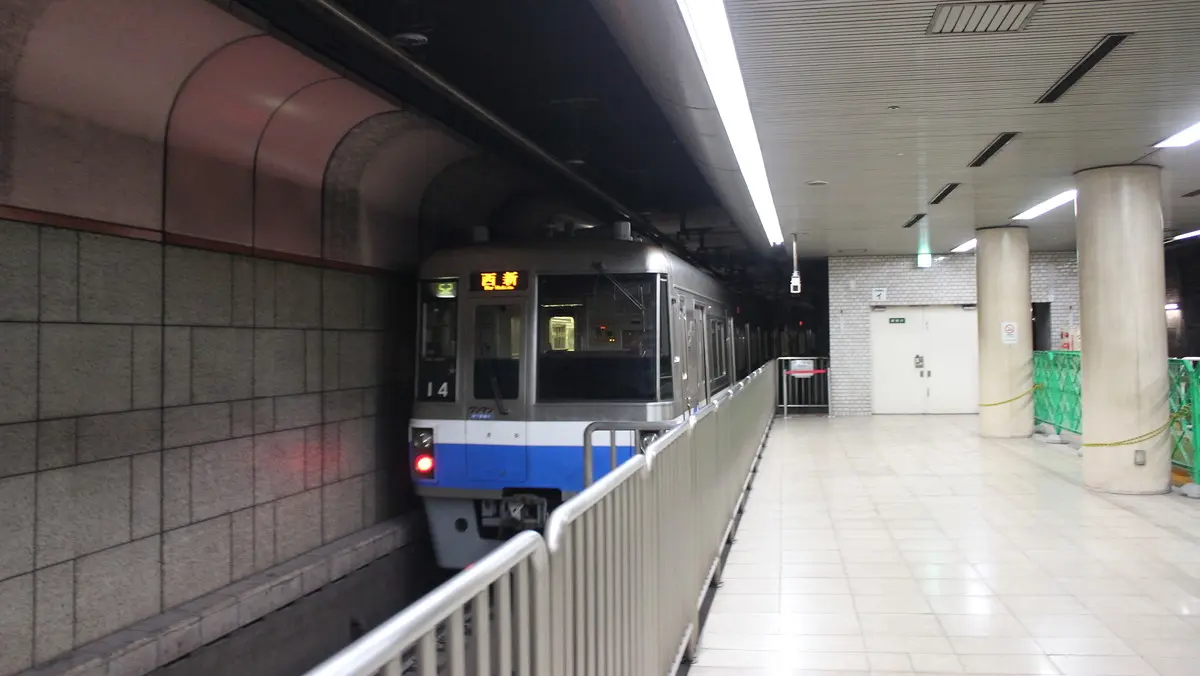 Hakozaki Line 1000N series subway train departing Nishijin Station
