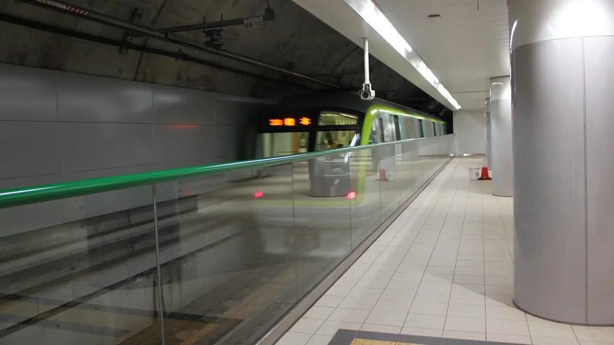 A 3000 series subway train on the Nanakuma Line departs from Hakata Station at high speed