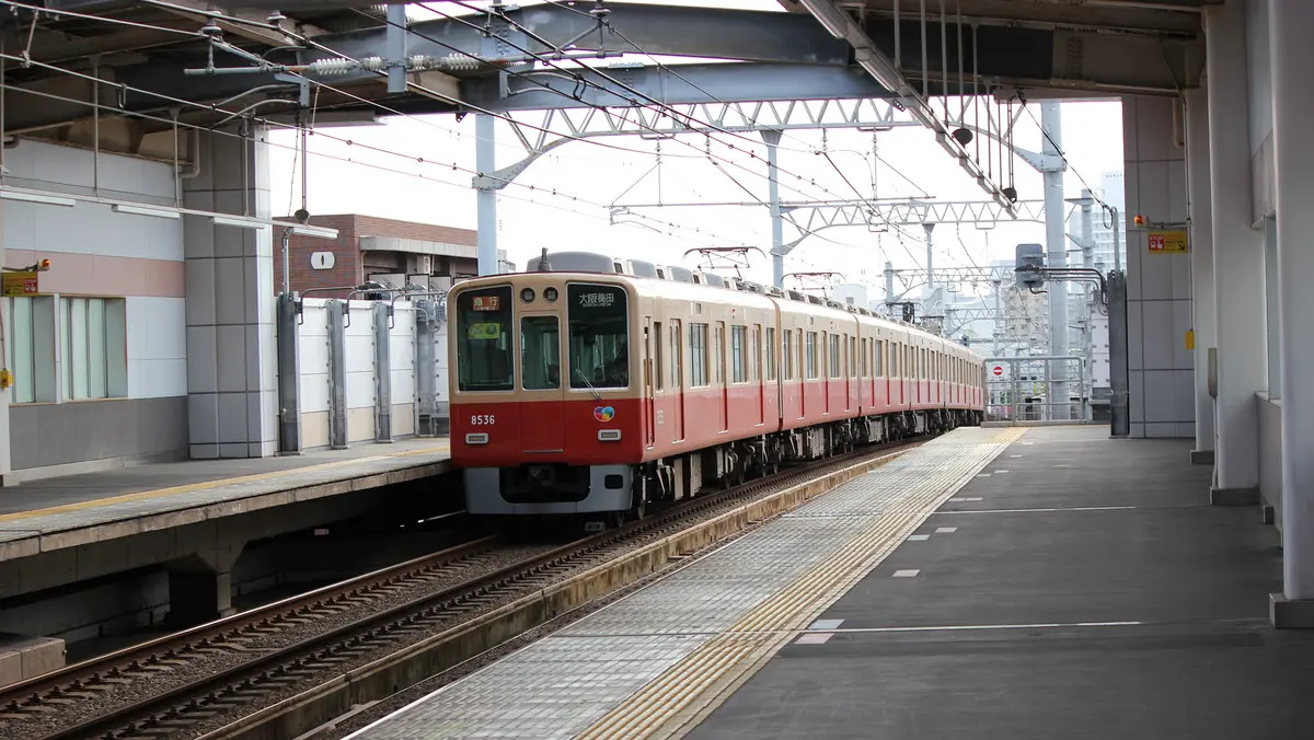A Hanshin Main Line 8000 series train departing from Imazu Station