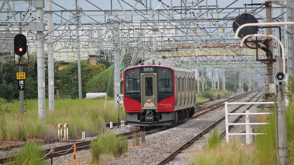 Shinano Railway Line SR1 series train departing from Shinonoi Station